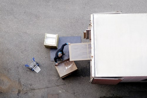 Removals team preparing a flat move in Harrow with boxes and furniture