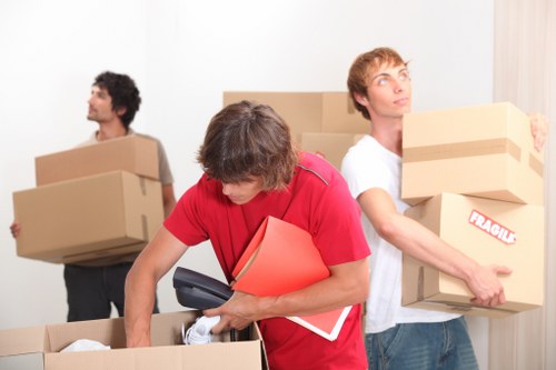 Trained removals staff using PPE while loading a van