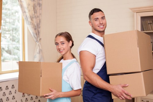 Professional man with van service in Harrow handling moving boxes