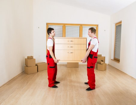Careful lifting of furniture during a flat removal in Harrow